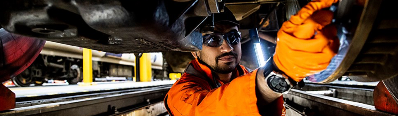 Rail Engineer working beneath a carraige